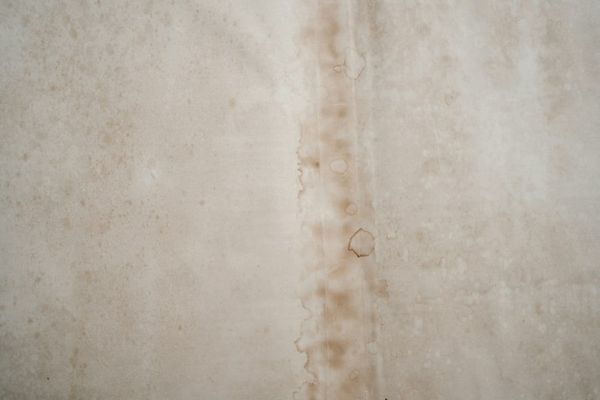 Water damage stain on ceiling from leaking air conditioner